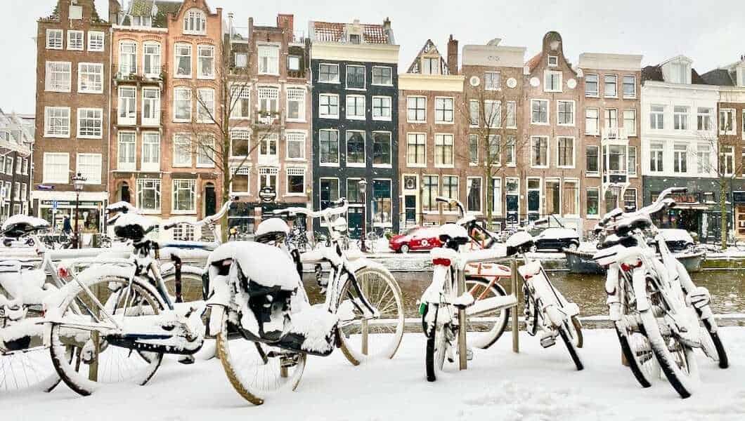 Snow in Amsterdam by the canal