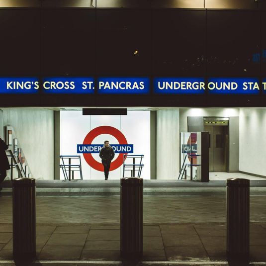 A person emerges from Kings Cross St Pancras underground station in London