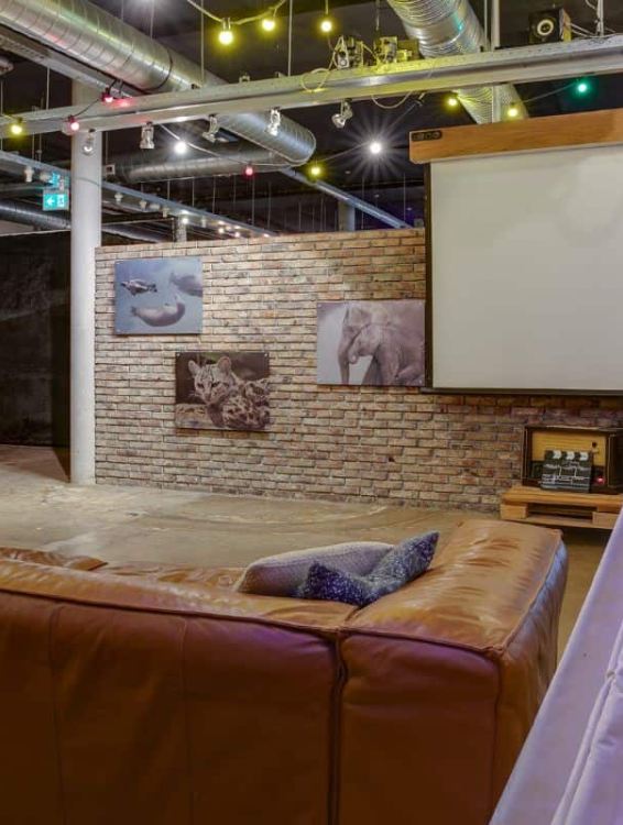 projector screen for movies and seating at clink mama amsterdam