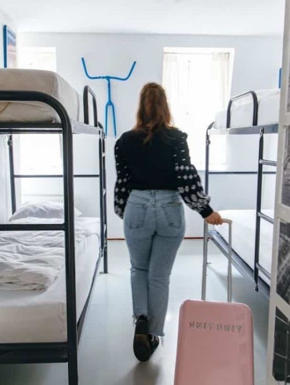 someone entering a four bed dorm at clinkcoco hostel in amsterdam
