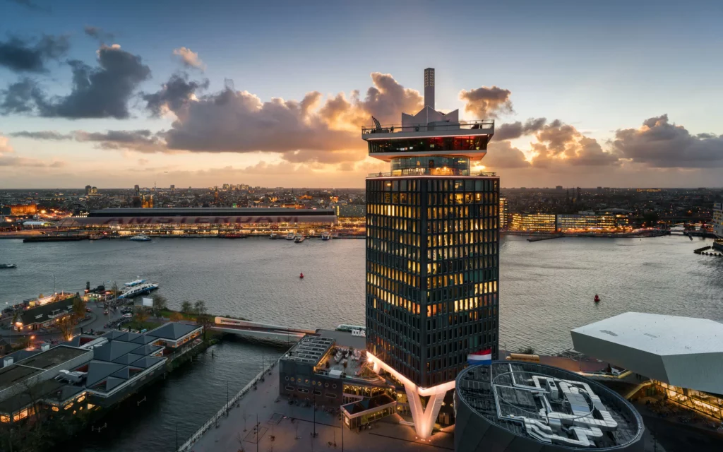 A view of the A’DAM Tower at sunset with river in the background