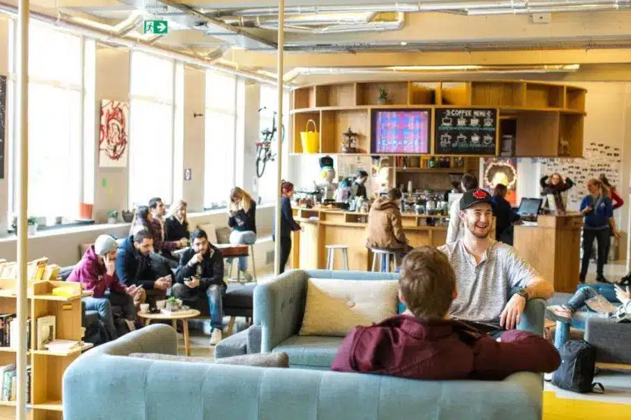 guests relaxing in the reception area of clinknoord hostel in amsterdam
