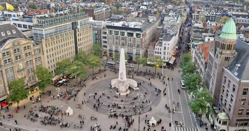 groups gather at touristic landmarks in the city of amsterdam