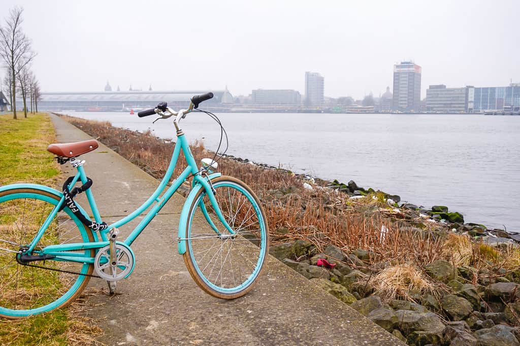 Blue pushbike parked by the river