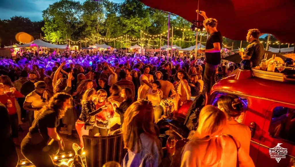 Large crowd under colourful lights at Bacchus Wine Festival