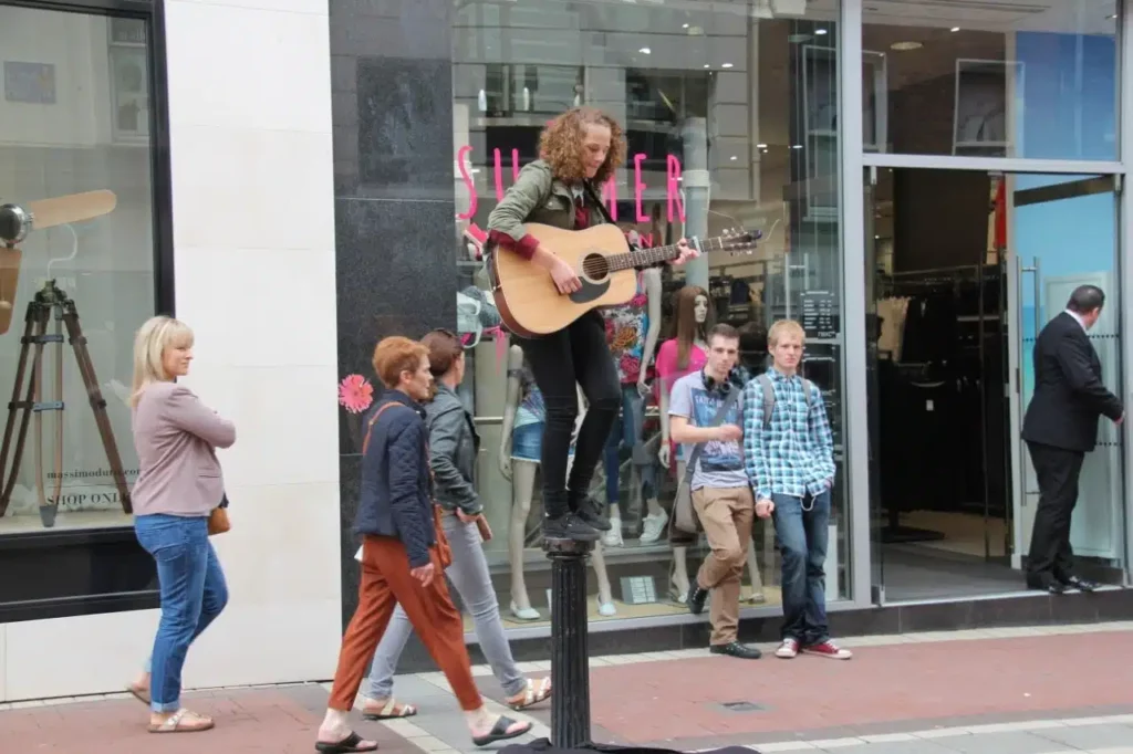A busker playing guitar on Grafton Street Dublin