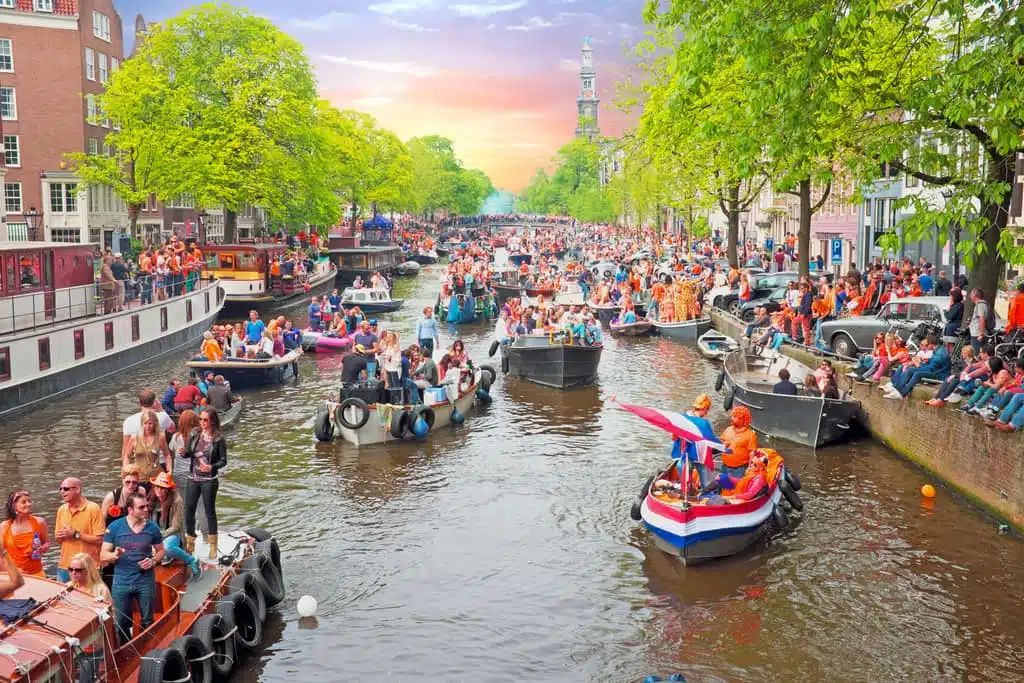 Boats on an Amsterdam canal during King's Day