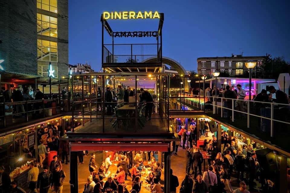 Busy dining area on two floors at Dinerama in Shoreditch