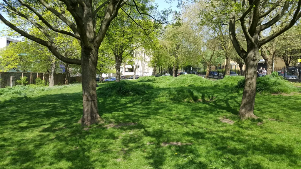 Trees and green grass in Joseph Grimaldi Park near Kings Cross