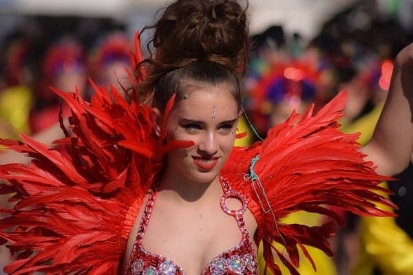 Girl in red feather costume for Notting Hill Carnival