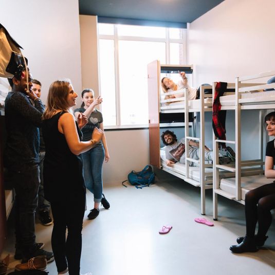 Group in mixed dorm room with bunk beds
